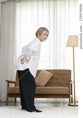 Senior woman with lower back pain 129974696