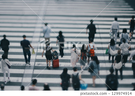 People crossing a pedestrian crossing 129974914