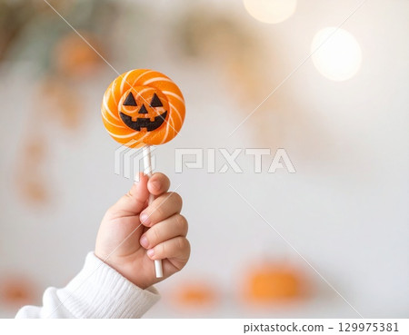 Hand holding Halloween candy 129975381