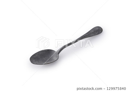 Antique spoon on a white background 129975840