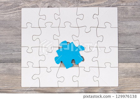 White and blue puzzle. Symbol of Autism Spectrum Disorder. Autism Awareness Day 129976138