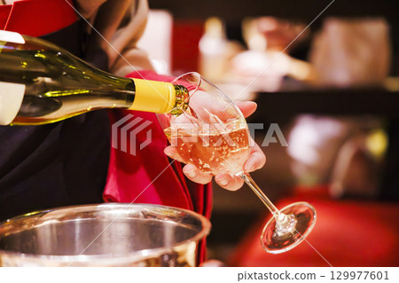 一名男子在餐廳倒冰鎮白酒 一名男子在餐廳倒冰鎮白酒 129977601