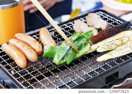 Barbecue cooked on a portable stove specially designed for yakiniku Barbecue cooked on a portable stove specially designed for yakiniku 129977623