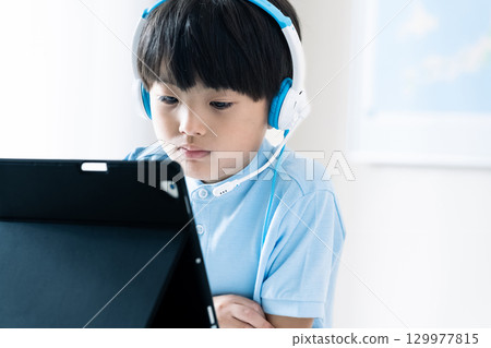 Boy taking online classes 129977815