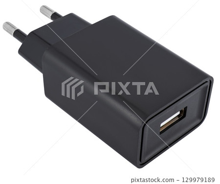 Power adapter for charging gadgets, black, on a white background in isolation. 129979189