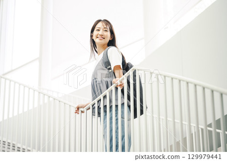 A woman going out alone with a backpack 129979441