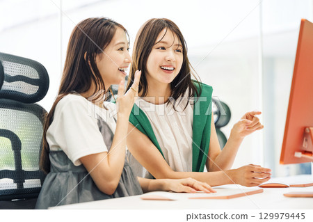 A young career woman working at a production company 129979445