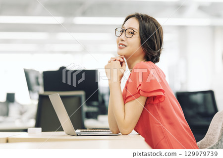 A career woman doing desk work in the office A career woman doing desk work in the office 129979739