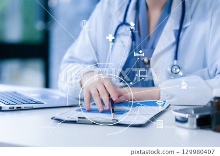 Medical Technology Concepts The doctor is working on a tablet and audio player and a digital tablet computer in a modern office in the morning at the desk. Medical Technology Concepts The doctor is working on a tablet and audio player and a digital tablet computer in a modern office in the morning at the desk. 129980407