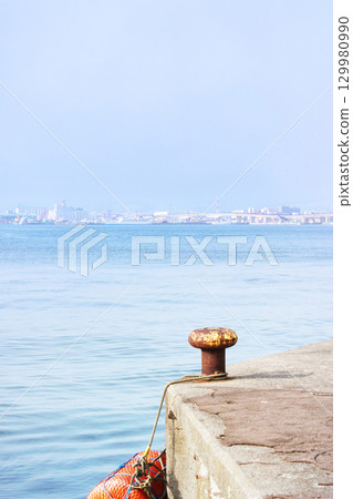 Bollard at the end of the harbor 129980990