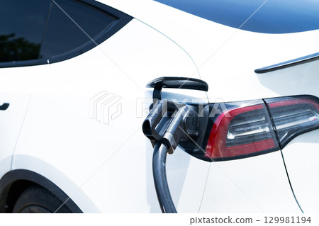 Electric vehicle charging station. Sustainable transport infrastructure with clean energy battery charging point for eco-friendly cars. Modern EV charging station. Zero emission transportation. 129981194