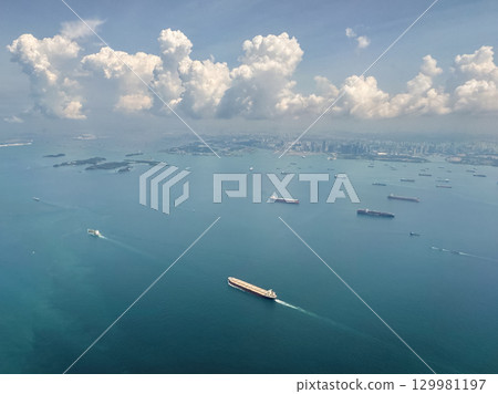 Aerial view of Singapore's coastline and shipping activity during daytime over calm waters 129981197