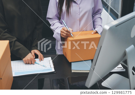 Portrait of Starting small businesses SME owners, two Asian woman check online orders Selling products working with boxs freelance work at home office, sme business online small medium enterprise 129981775