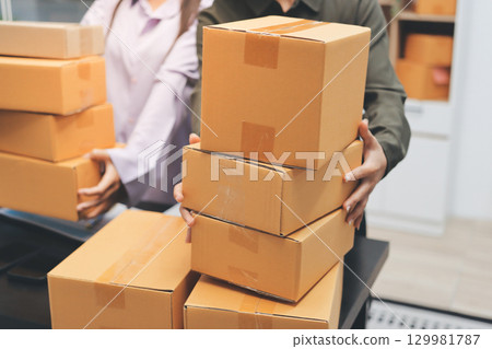 Portrait of Starting small businesses SME owners, two Asian woman check online orders Selling products working with boxs freelance work at home office, sme business online small medium enterprise 129981787