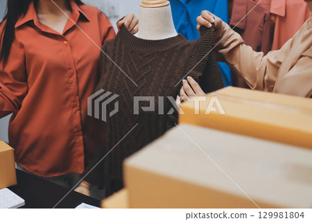 Portrait of Starting small businesses SME owners, two Asian woman check online orders Selling products working with boxs freelance work at home office, sme business online small medium enterprise Portrait of Starting small businesses SME owners, two Asian woman check online orders Selling products working with boxs freelance work at home office, sme business online small medium enterprise 129981804