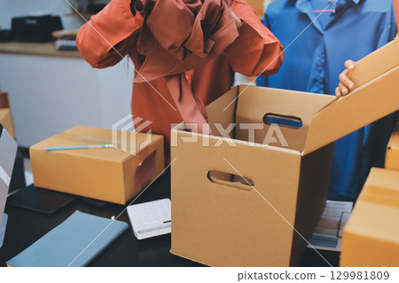 Portrait of Starting small businesses SME owners, two Asian woman check online orders Selling products working with boxs freelance work at home office, sme business online small medium enterprise 129981809