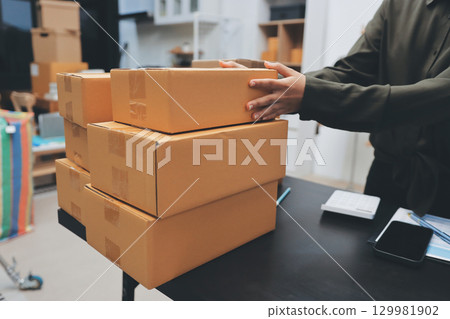 Portrait of Starting small businesses SME owners, two Asian woman check online orders Selling products working with boxs freelance work at home office, sme business online small medium enterprise 129981902