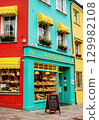 A colorful street corner with a bakery and gorgeous buildings 129982108