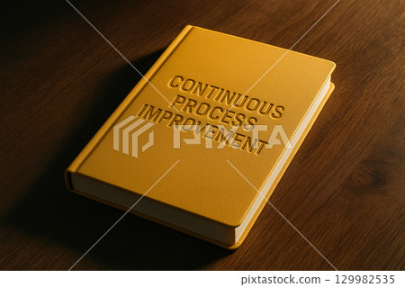 Continuous Process Improvement text on closed yellow notebook resting on wooden surface. Business improvement concept Continuous Process Improvement text on closed yellow notebook resting on wooden surface. Business improvement concept 129982535