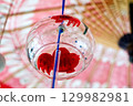 Goldfish-patterned wind chimes hanging from a Japanese umbrella 129982981