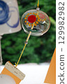 Glass wind chimes swaying in the wind 129982982