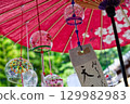 Many wind chimes hanging from a Japanese umbrella 129982983