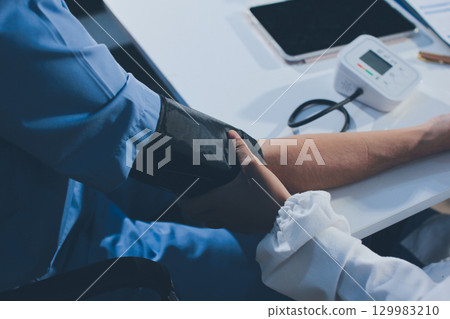 Doctor checking patient arterial blood pressure in hospital. Health care Concept Doctor checking patient arterial blood pressure in hospital. Health care Concept 129983210
