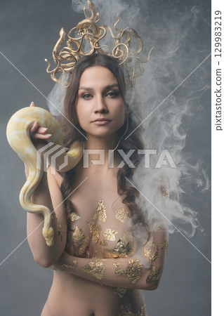 Beauty and strength unite in a captivating artistic display with a snake 129983219