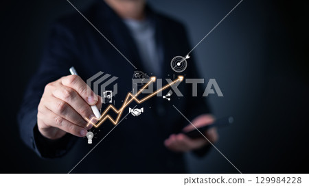 businessman touch graph with a virtual interface, leveraging technology for a business plan, industry insights, and achievement. Driving growth through advertisement and analyzing trend in e-commerce. 129984228