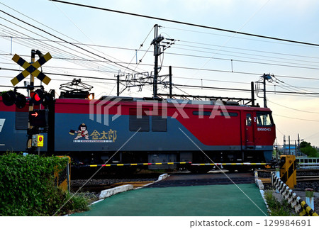 Freight train passing a level crossing 129984691