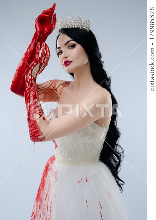 Bride in blood-soaked lingerie displays ominous beauty with a knife Bride in blood-soaked lingerie displays ominous beauty with a knife 129985328