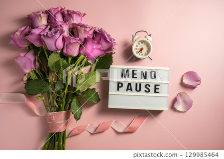 Word Menopause on light box with pink roses and alarm clock, flat lay, pink background Word Menopause on light box with pink roses and alarm clock, flat lay, pink background 129985464