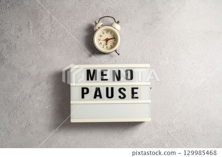 Word Menopause with alarm clock, flat lay, grey background Word Menopause with alarm clock, flat lay, grey background 129985468