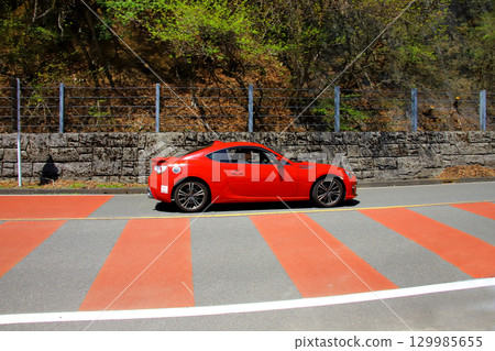 Drive a red sports car 129985655