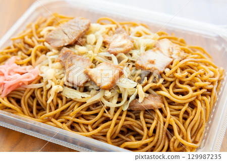 Delicious street-style fried noodles with sauce 129987235
