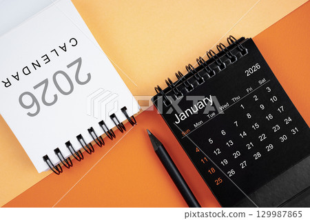 January 2026 desk calendar black and white color with pencil on orange color background. 129987865