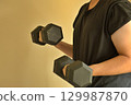 Man weigh training using dumb bells 129987870
