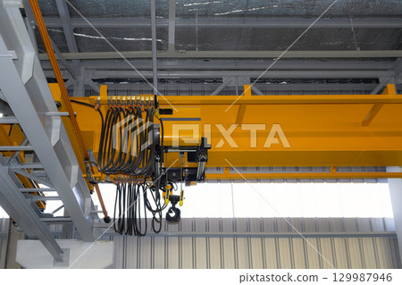 Overhead crane or lifting equipment inside factory or warehouse. Overhead crane or lifting equipment inside factory or warehouse. 129987946