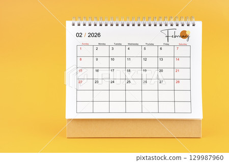 February 2026 Monthly desk calendar for 2026 year on yellow color background. 129987960
