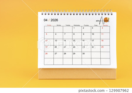 April 2026 Monthly desk calendar for 2026 year on yellow color background. 129987962