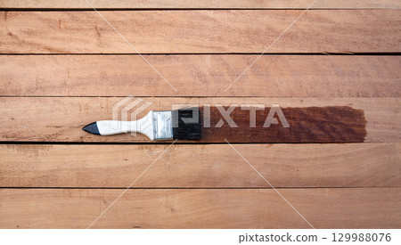 Paint brush and wood material in construction work. 129988076