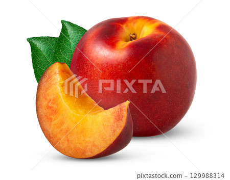 Red nectarine peach and cut in a slice with green leaf isolated. 129988314