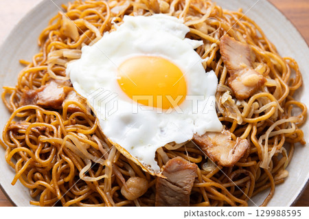 Delicious fried noodles with sauce and a fried egg 129988595