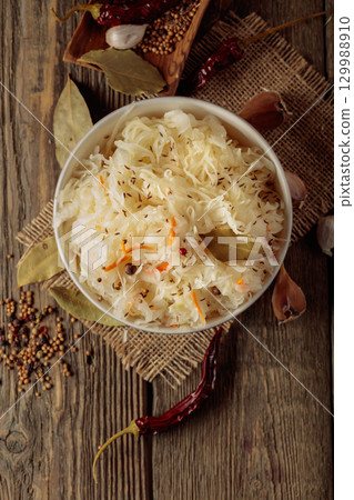 Traditional German sauerkraut on a old rustic wooden table. 129988910