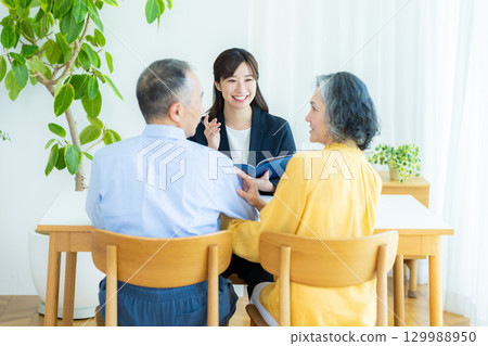 Consultant talking to a senior couple Consultant talking to a senior couple 129988950