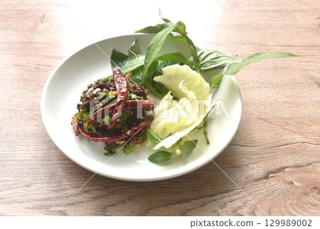 spicy fried chop pork salad Thai northern style with fresh vegetable on plate 129989002