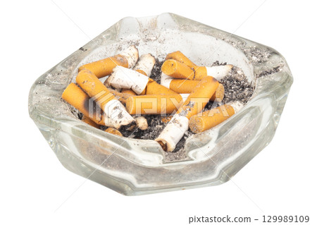 A glass ashtray with extinguished cigarette butts inside on a white background A glass ashtray with extinguished cigarette butts inside on a white background 129989109