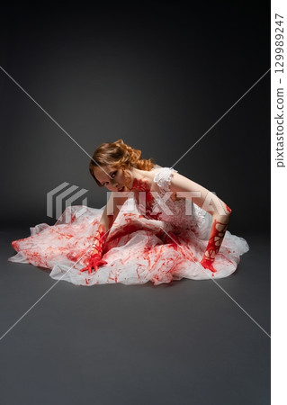 Bridal beauty with a katana amidst a dramatic depiction of murder and blood 129989247