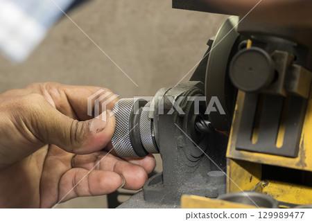 The operation of universal tool grinding machine with the end mill tool. 129989477