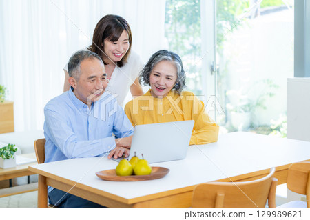 Parent-child watching personal computer in the living room 129989621